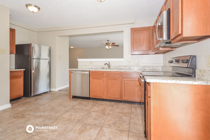 a kitchen with stainless steel appliances and wooden cabinets