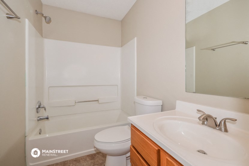 a bathroom with a sink and a toilet and a bath tub