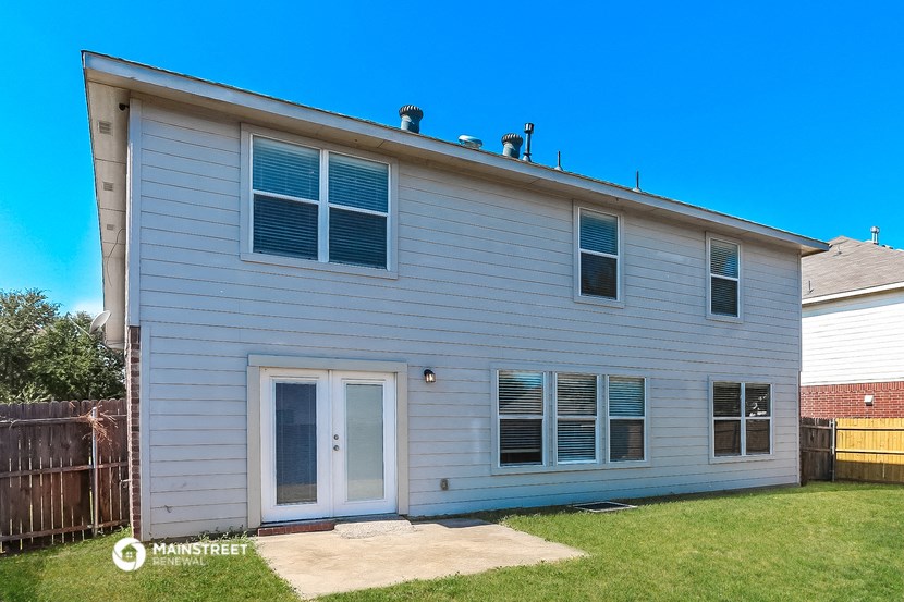 a white house with a yard and a blue sky