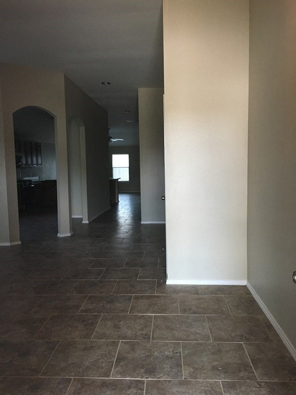 a view of the hallway from the living room into the dining room and the kitchen