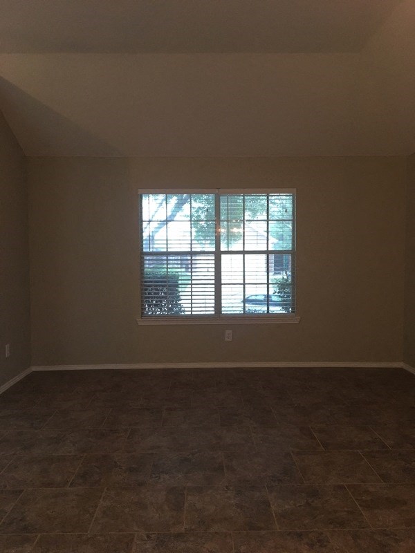 an empty living room with a large window