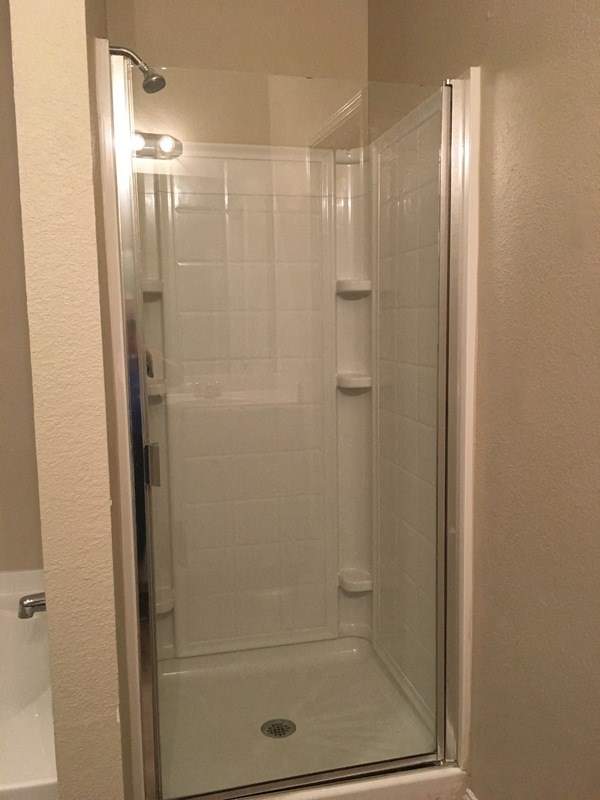 a shower in a bathroom with a glass door