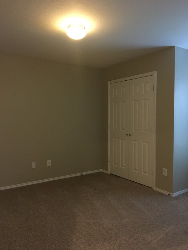 an empty room with a door and a light on the ceiling