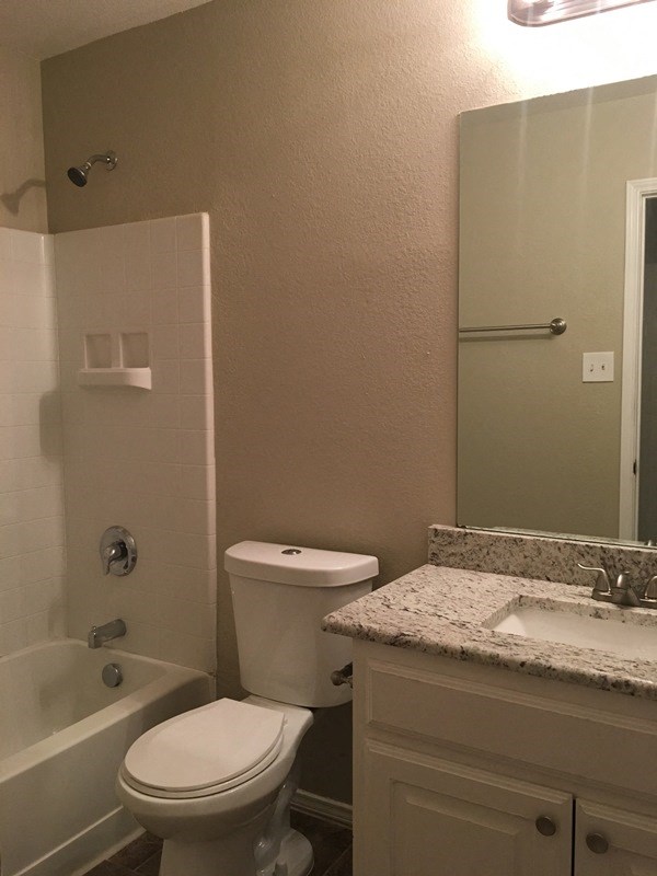 a bathroom with a toilet and a sink and a bath tub
