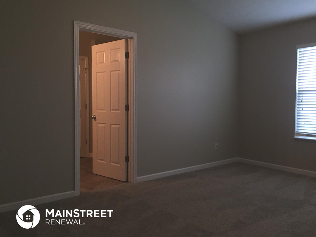 an empty room with a door and a window