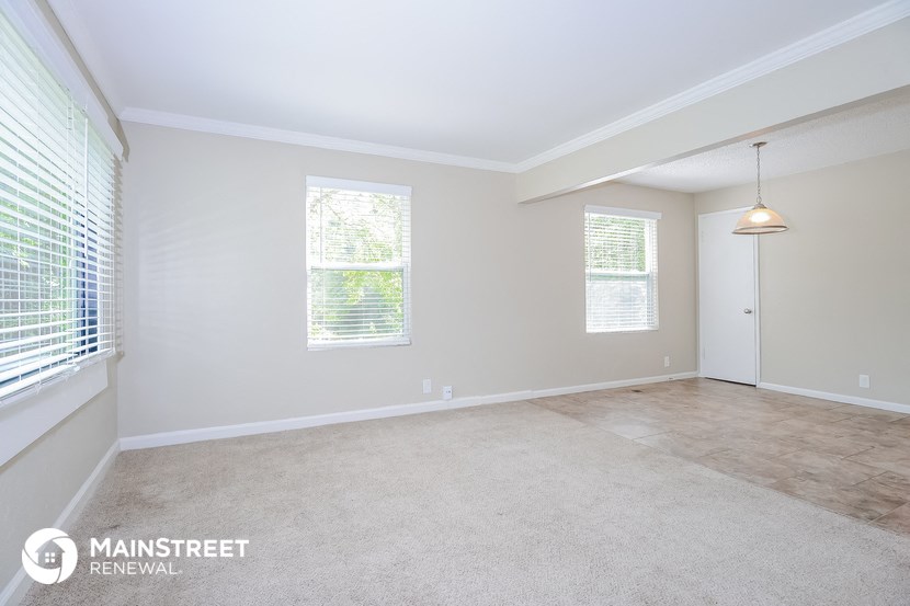 the living room and dining room of an apartment