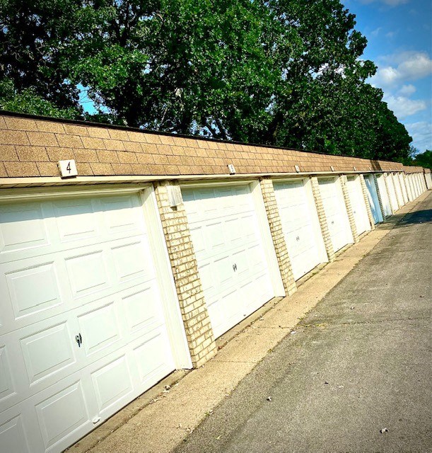 a row of garages with white garage doors
