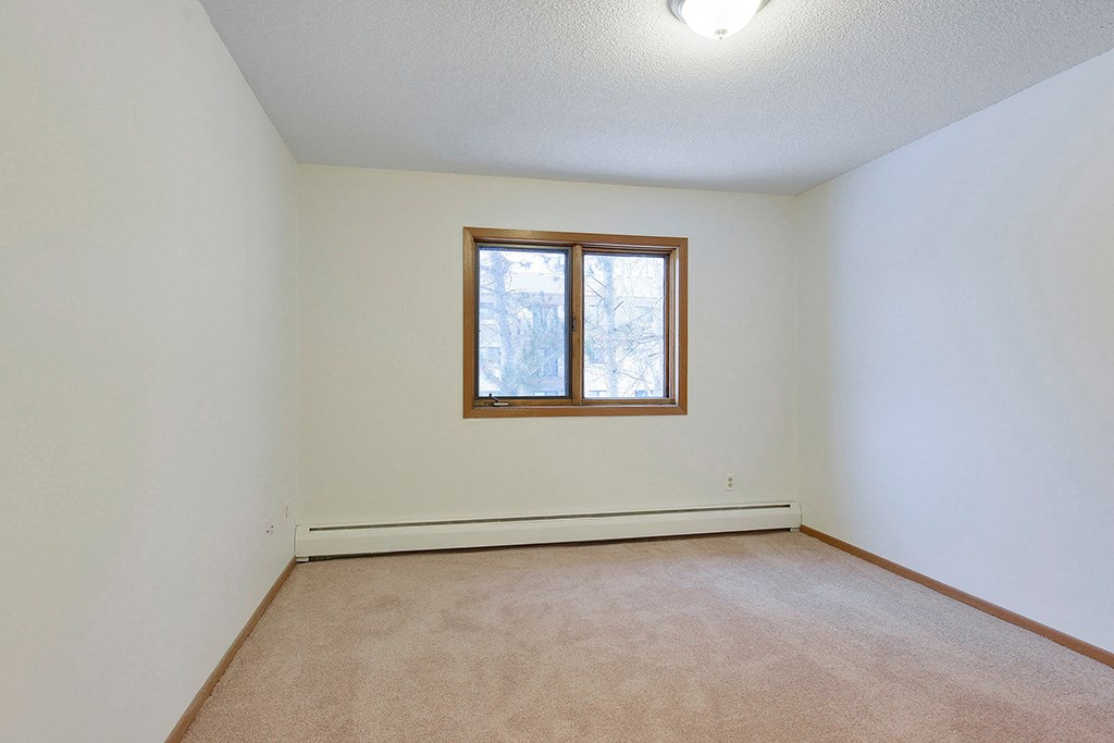 the living room of an empty house with a window