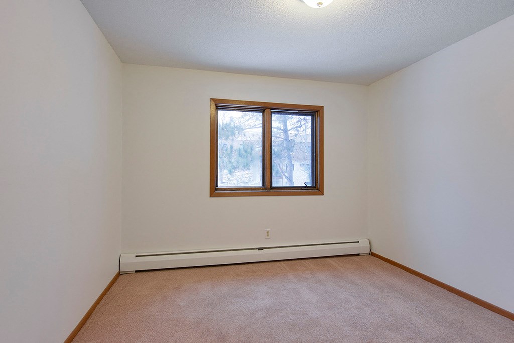 the living room of an empty house with a window