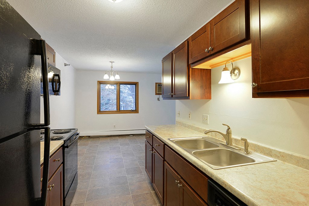 a kitchen with a sink and a refrigerator