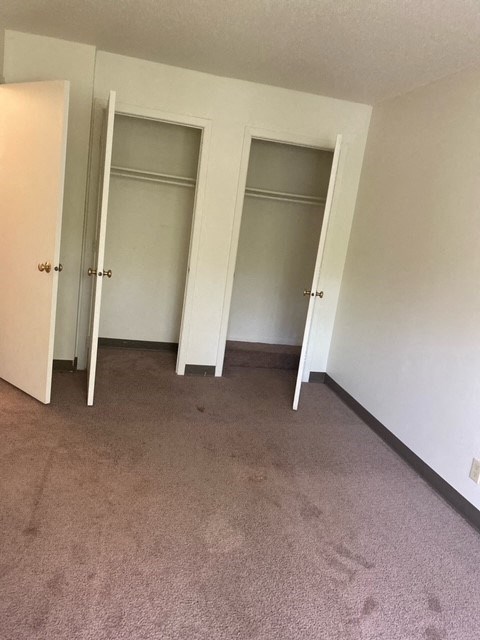 an empty room with three closet doors in it