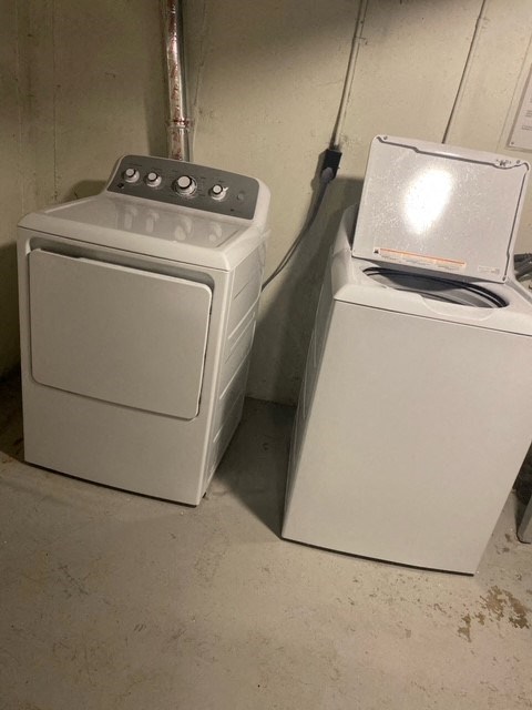 two washing machines sitting next to each other in a room