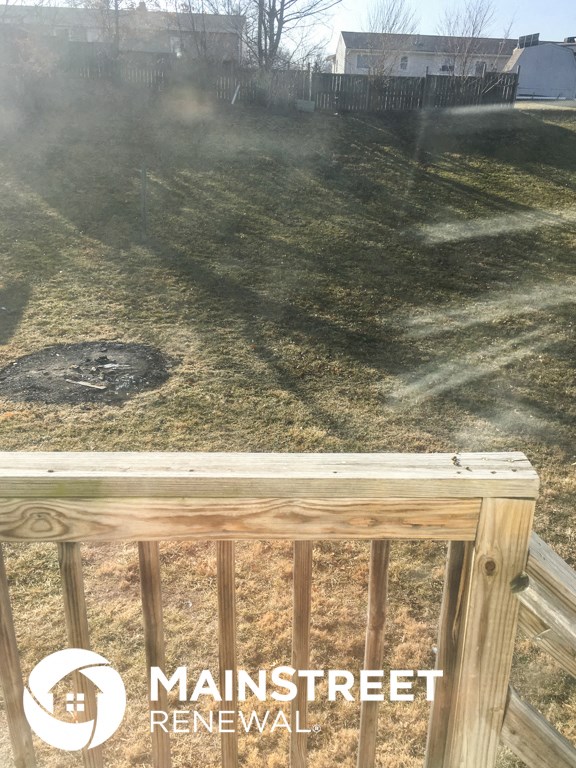 the back of a wood fence with smoke coming out of it