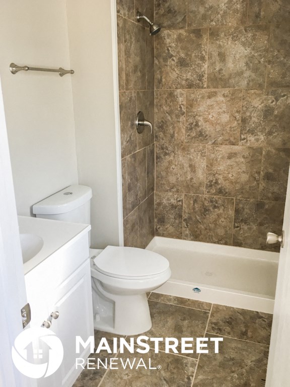 a small bathroom with a toilet and a shower