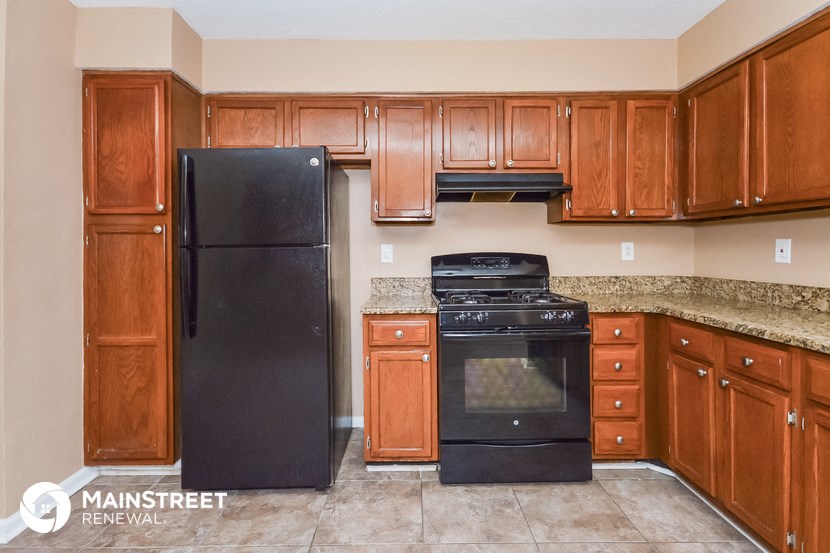 a kitchen with black appliances and wood cabinets