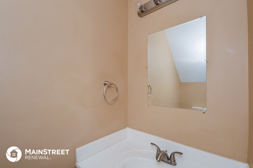 a small bathroom with a sink and a mirror