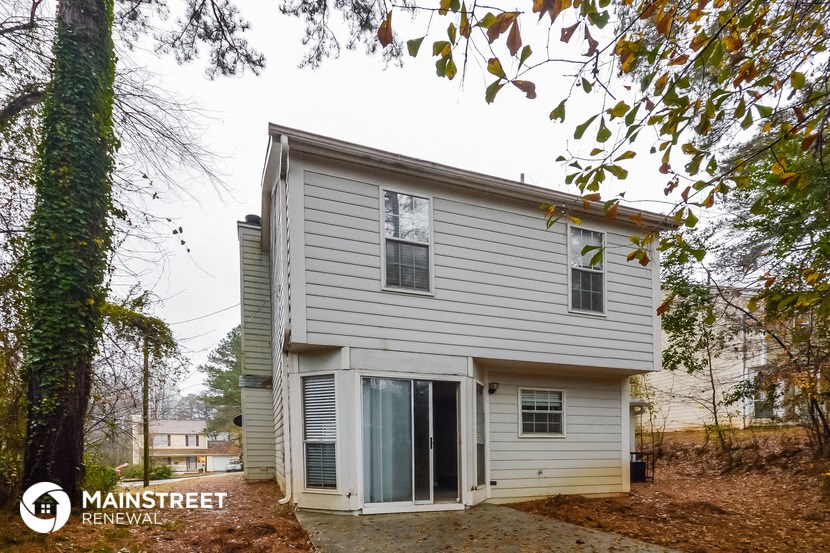 the back of the house with the garage door open