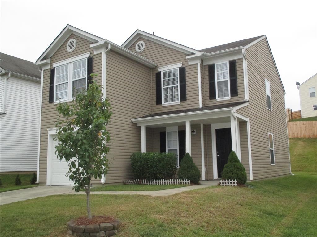 a house with a tree in the front yard