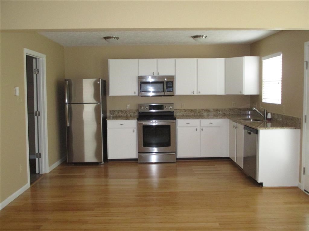 a kitchen with stainless steel appliances and white cabinets