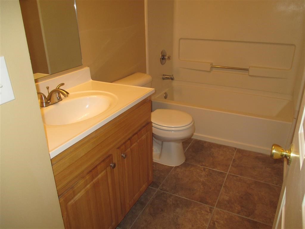 a bathroom with a sink toilet and a bath tub