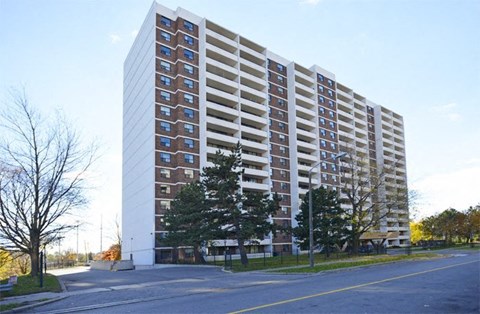 A tall residential building with many windows and balconies.