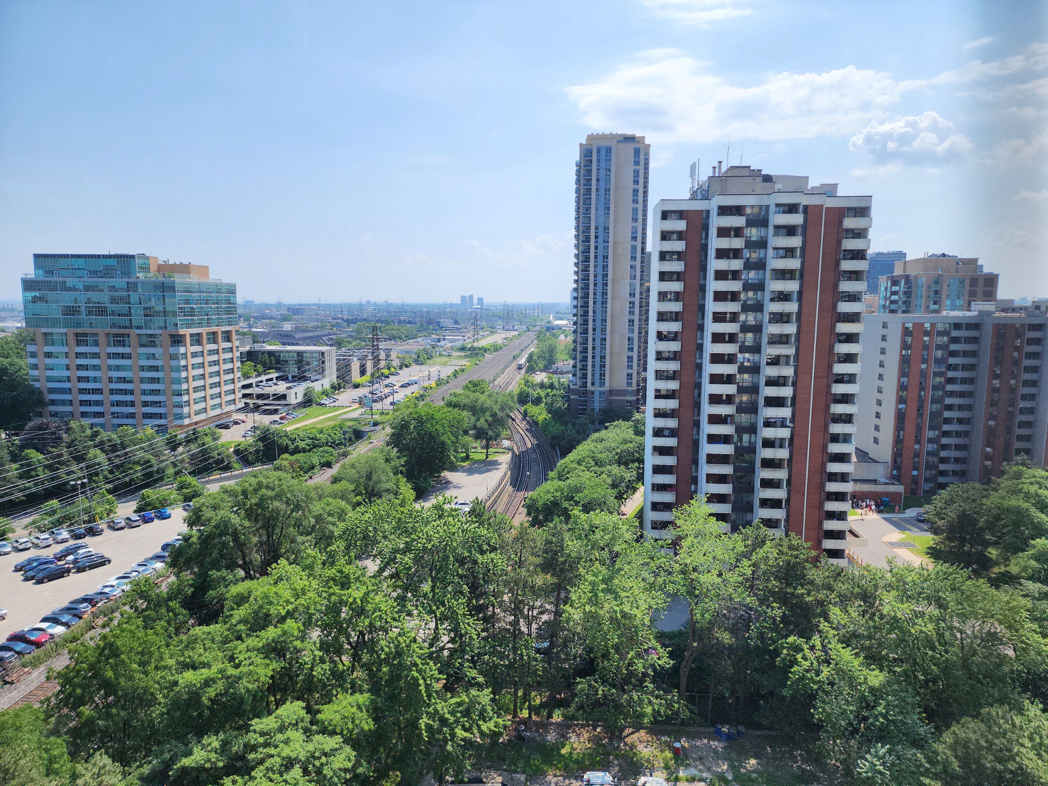 an aerial view of a city with tall buildings and trees