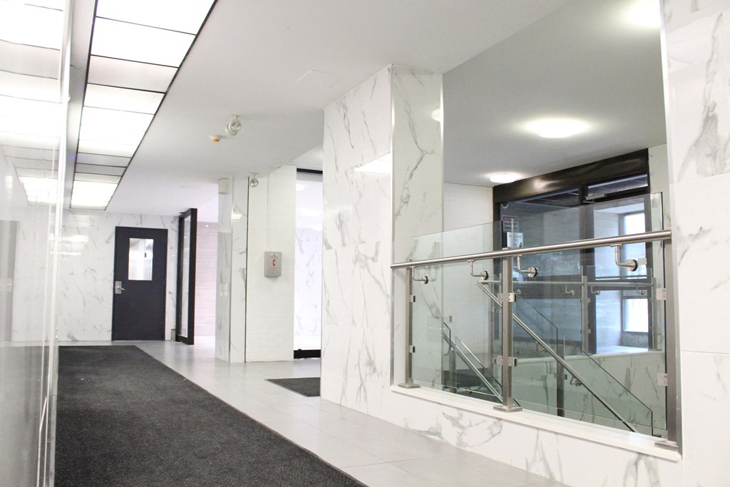 a view of the lobby of a building with a glass door