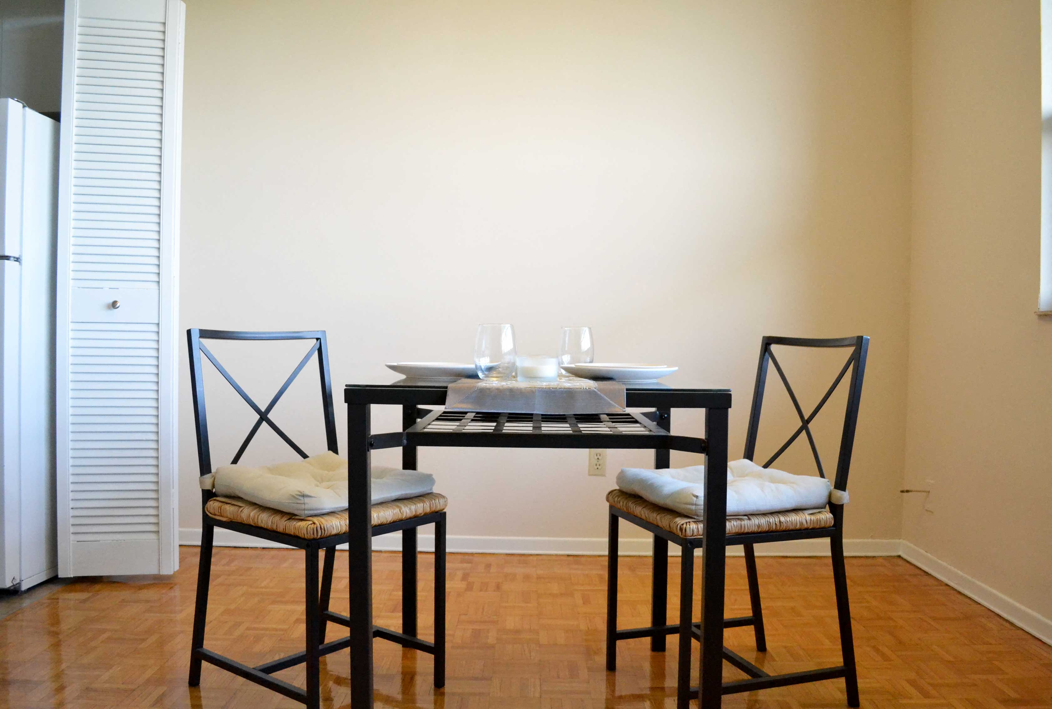 a dining room with a table and three chairs