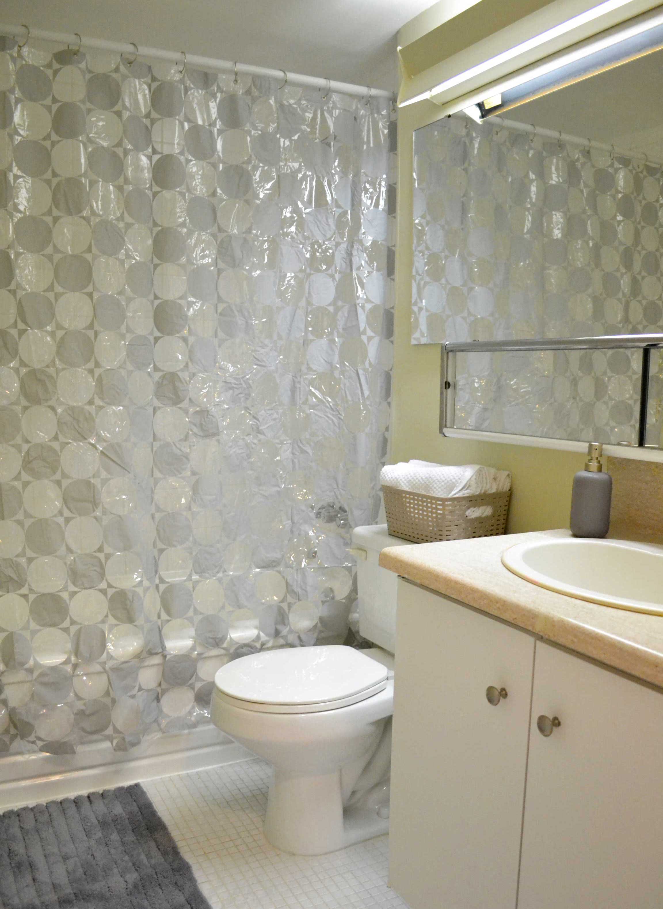 a bathroom with a toilet and a shower curtain