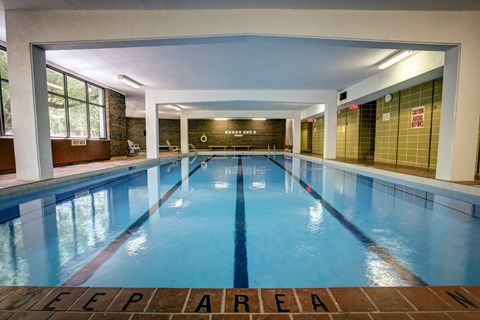 a swimming pool in a building with a large window