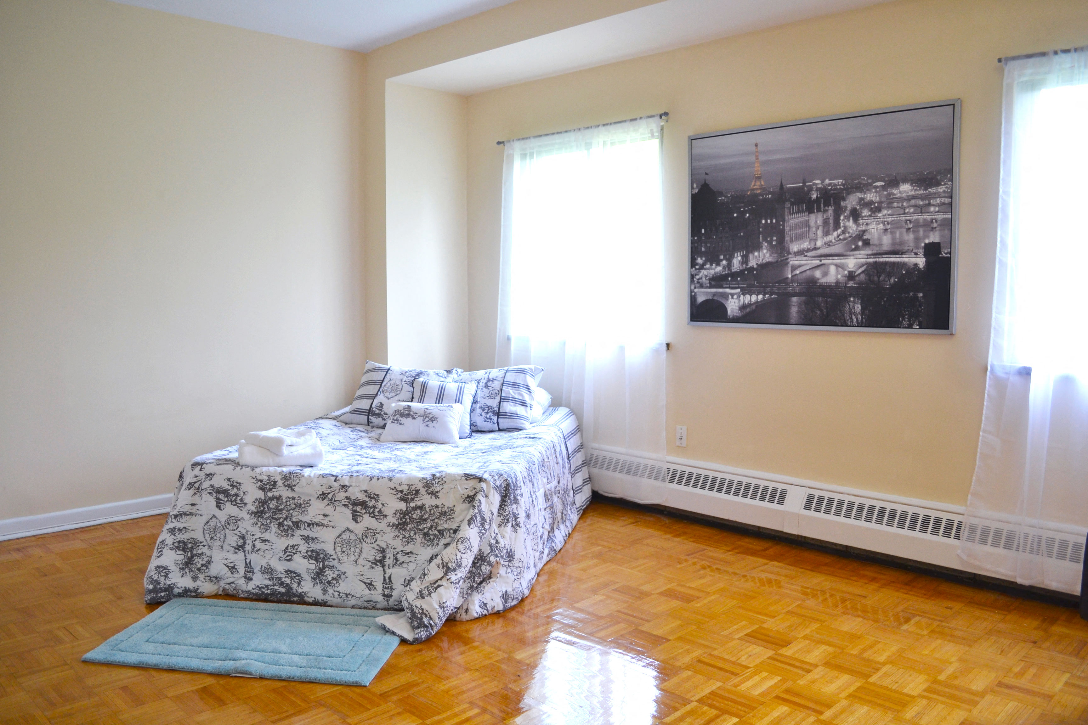 a bedroom with a bed and a painting on the wall