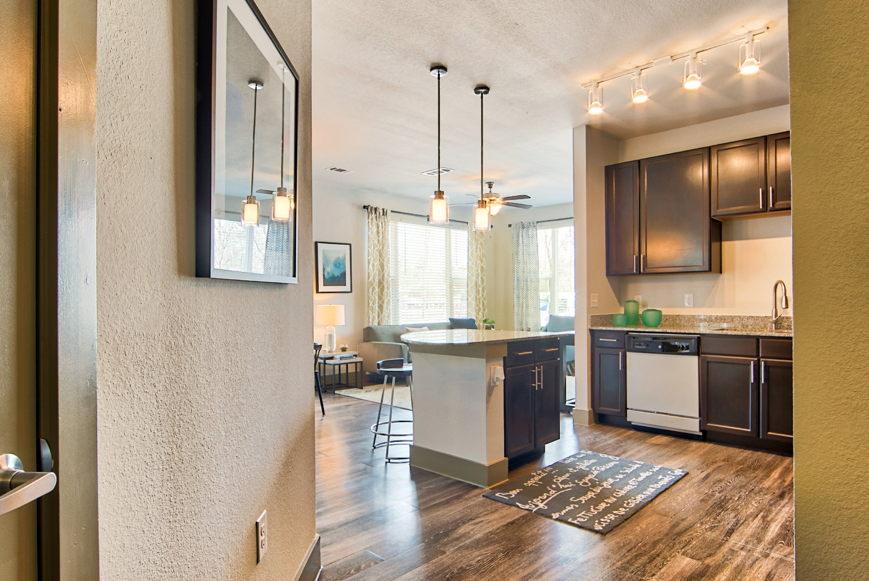 an open kitchen and living room with a dining area and a kitchen island