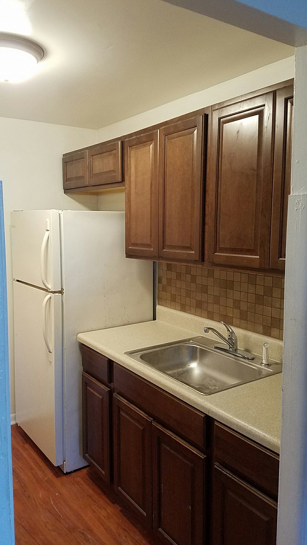 a kitchen with a sink and a refrigerator
