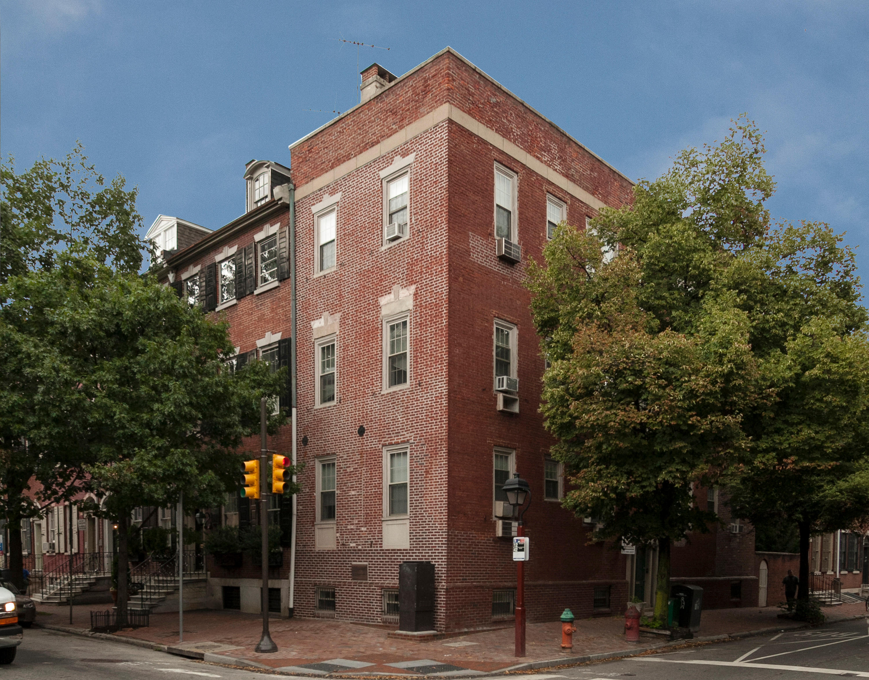 a red brick building on the corner of a city street