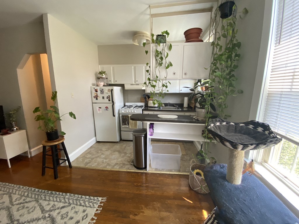 an aerial view of a kitchen with a stove refrigerator and sink