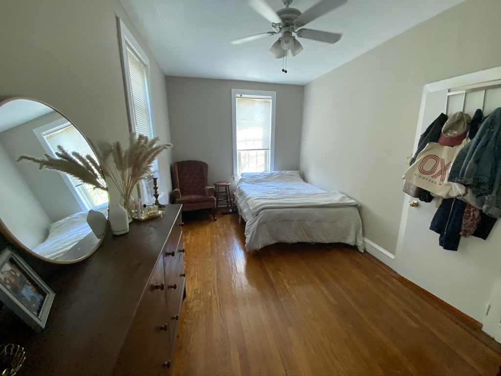 a bedroom with a bed and a dresser and a mirror