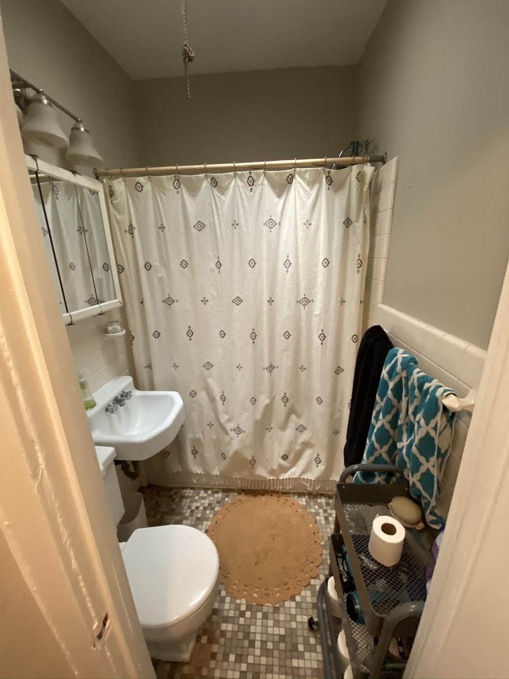 a small bathroom with a shower toilet and sink
