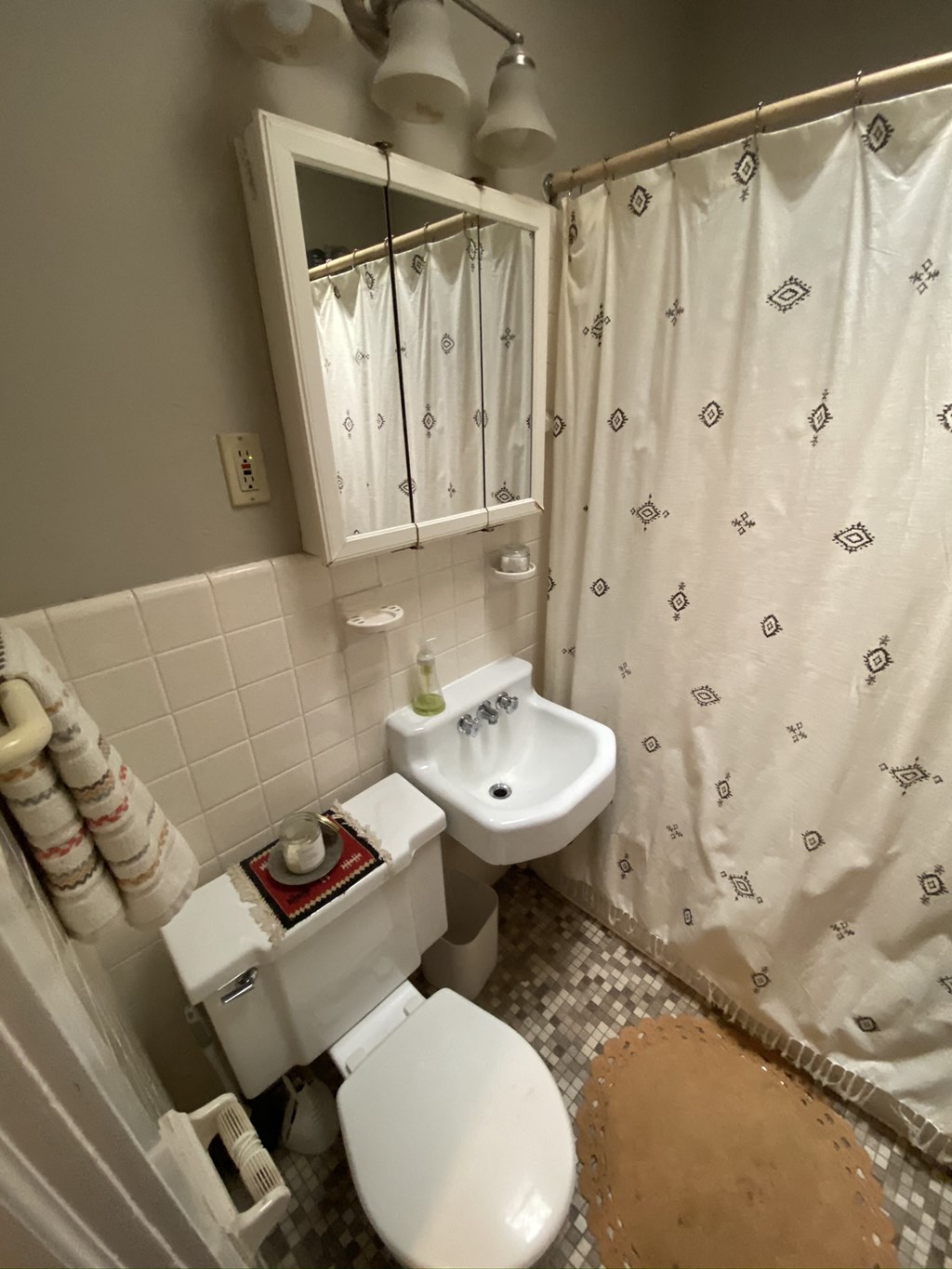a small bathroom with a shower toilet and sink