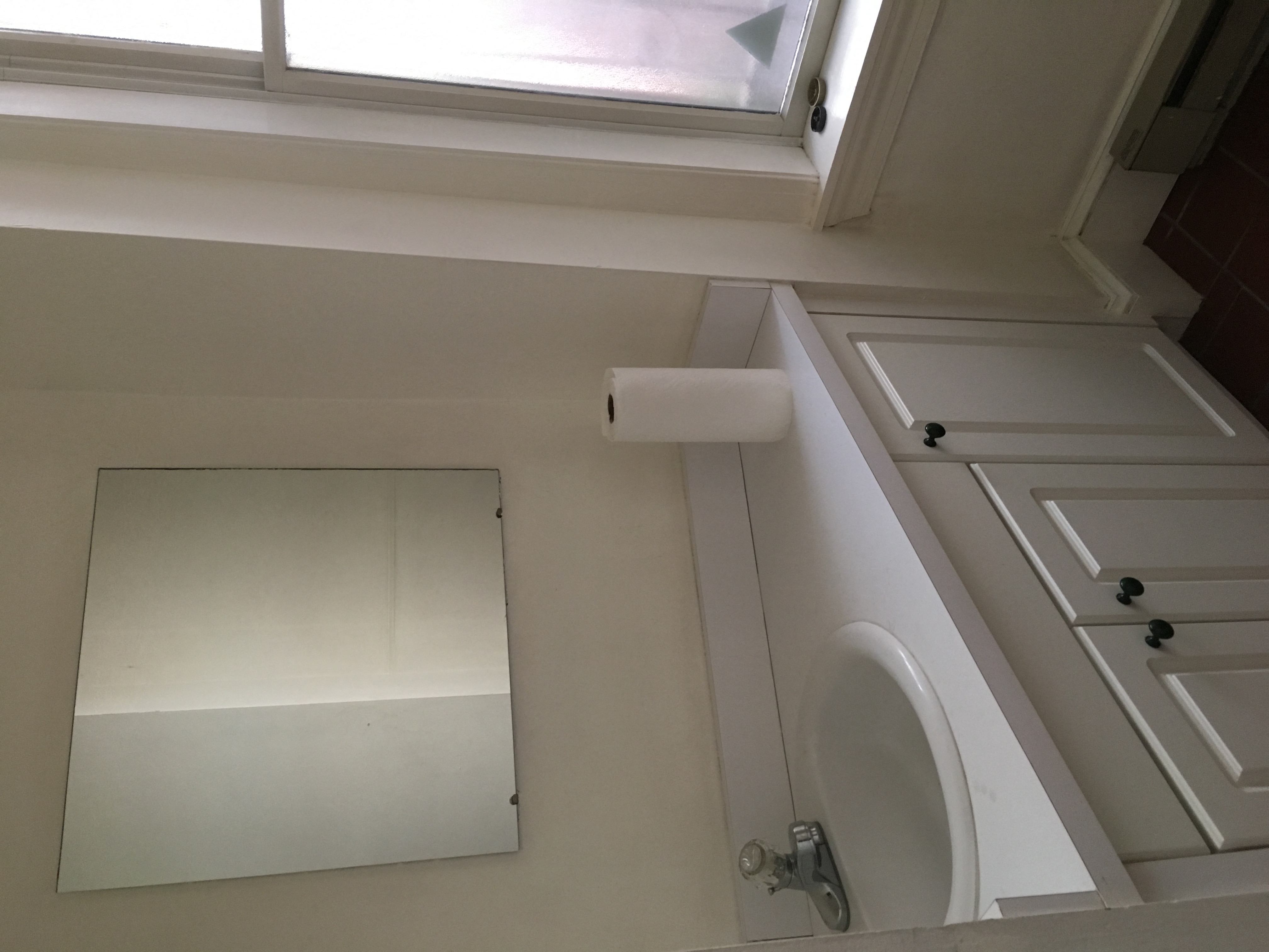 a bathroom with a toilet and a sink and a window