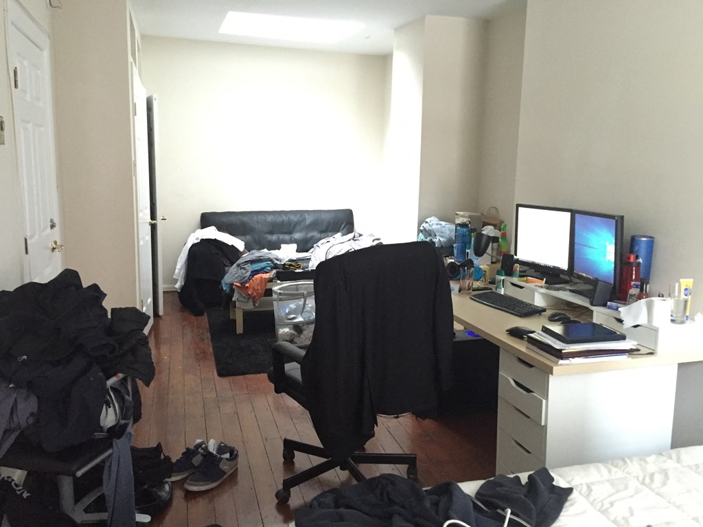 a messy room with a desk and a computer