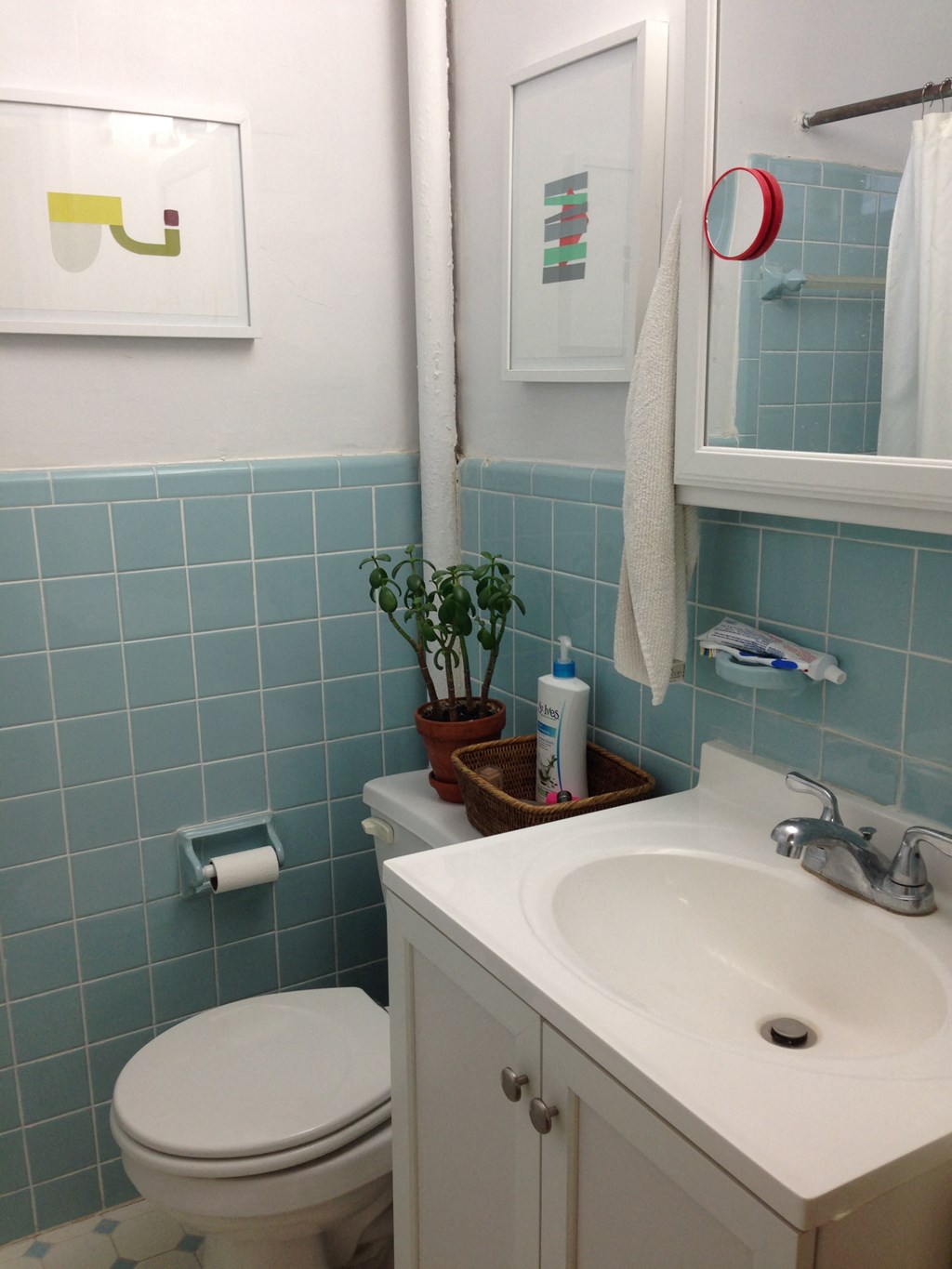 a blue and white bathroom with a toilet and a sink