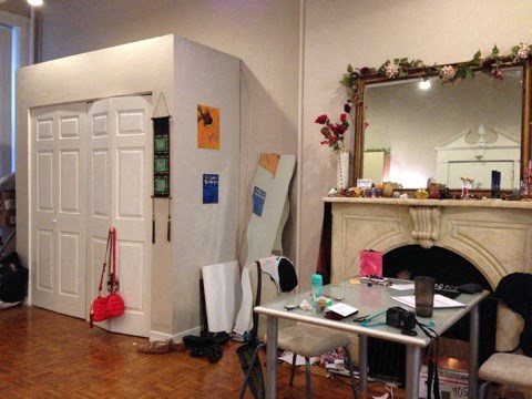 a living room with a table and a fireplace