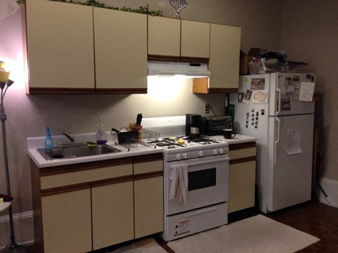a kitchen with a stove refrigerator and sink