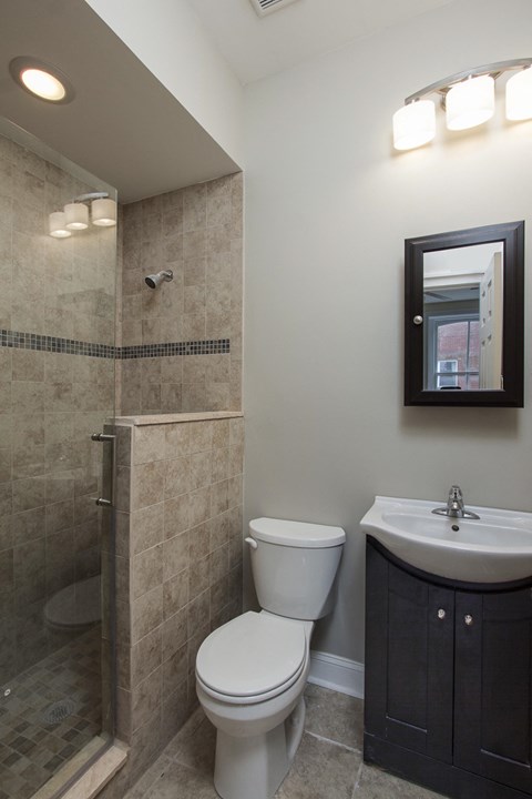 a small bathroom with a shower toilet and sink