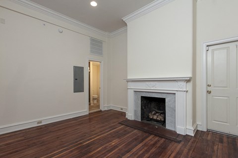 a living room with a fireplace and a door to a bathroom