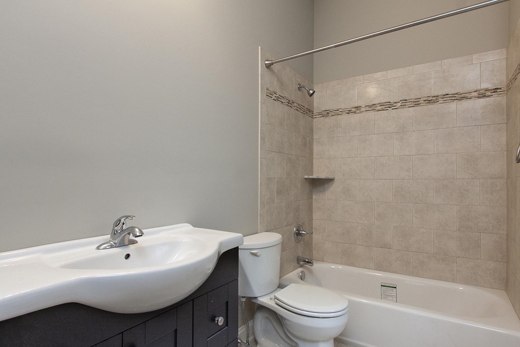 a bathroom with a sink and a toilet and a shower