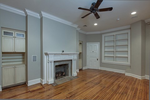 a living room with a fireplace and a wooden floor