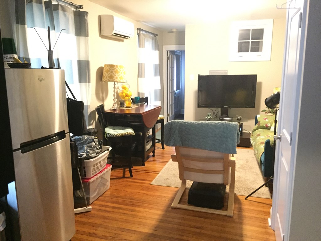 a living room filled with furniture and a tv