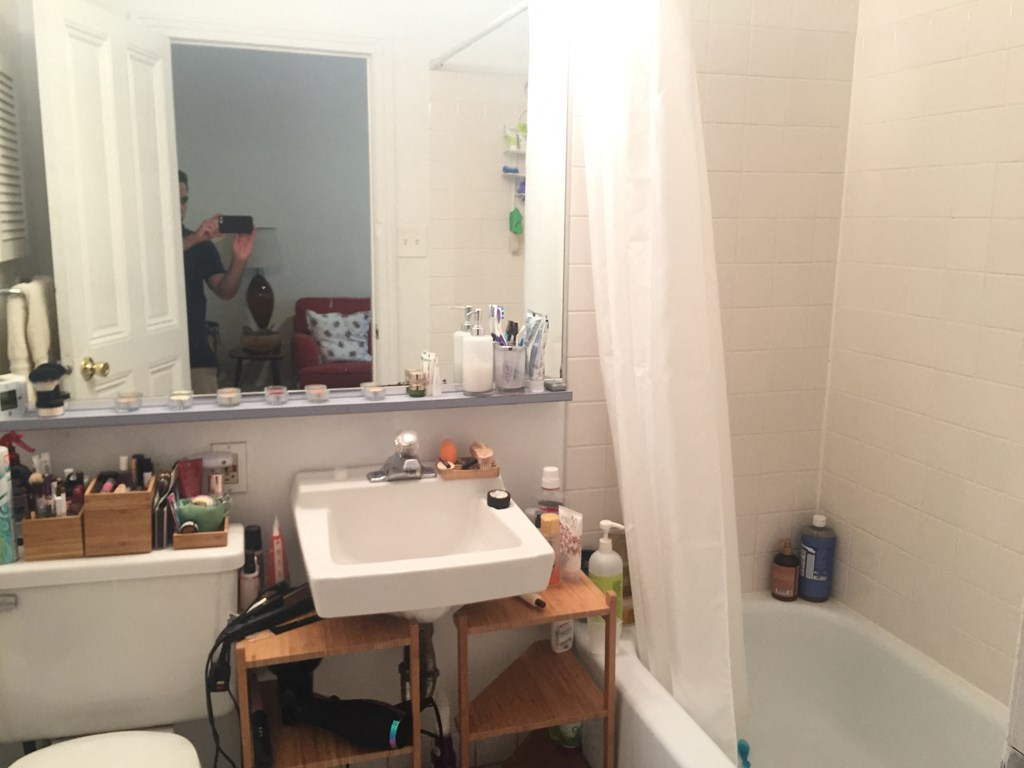 a bathroom with a sink and a mirror and a tub