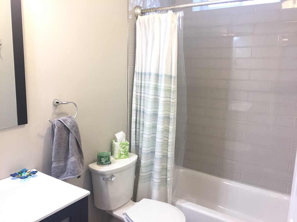 a small bathroom with a shower toilet and sink